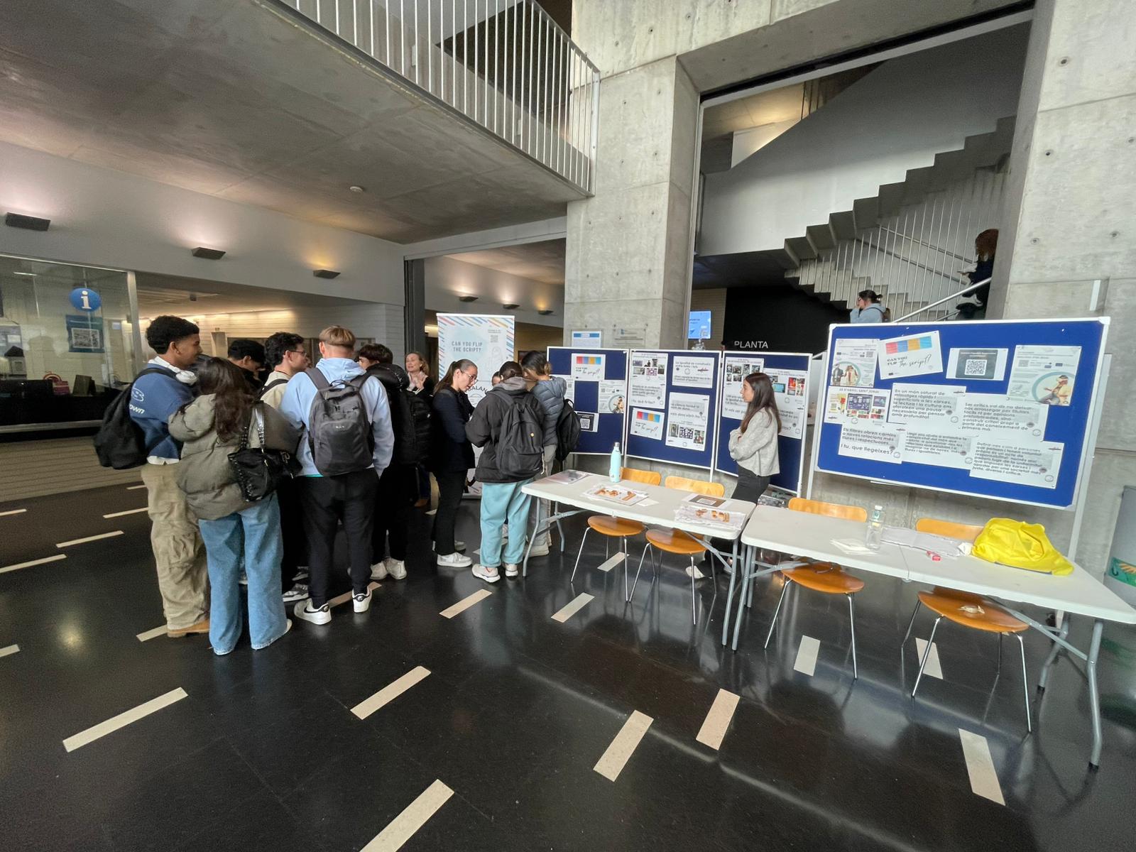 Students gathered around the VR Balance stand at the University of Barcelona.